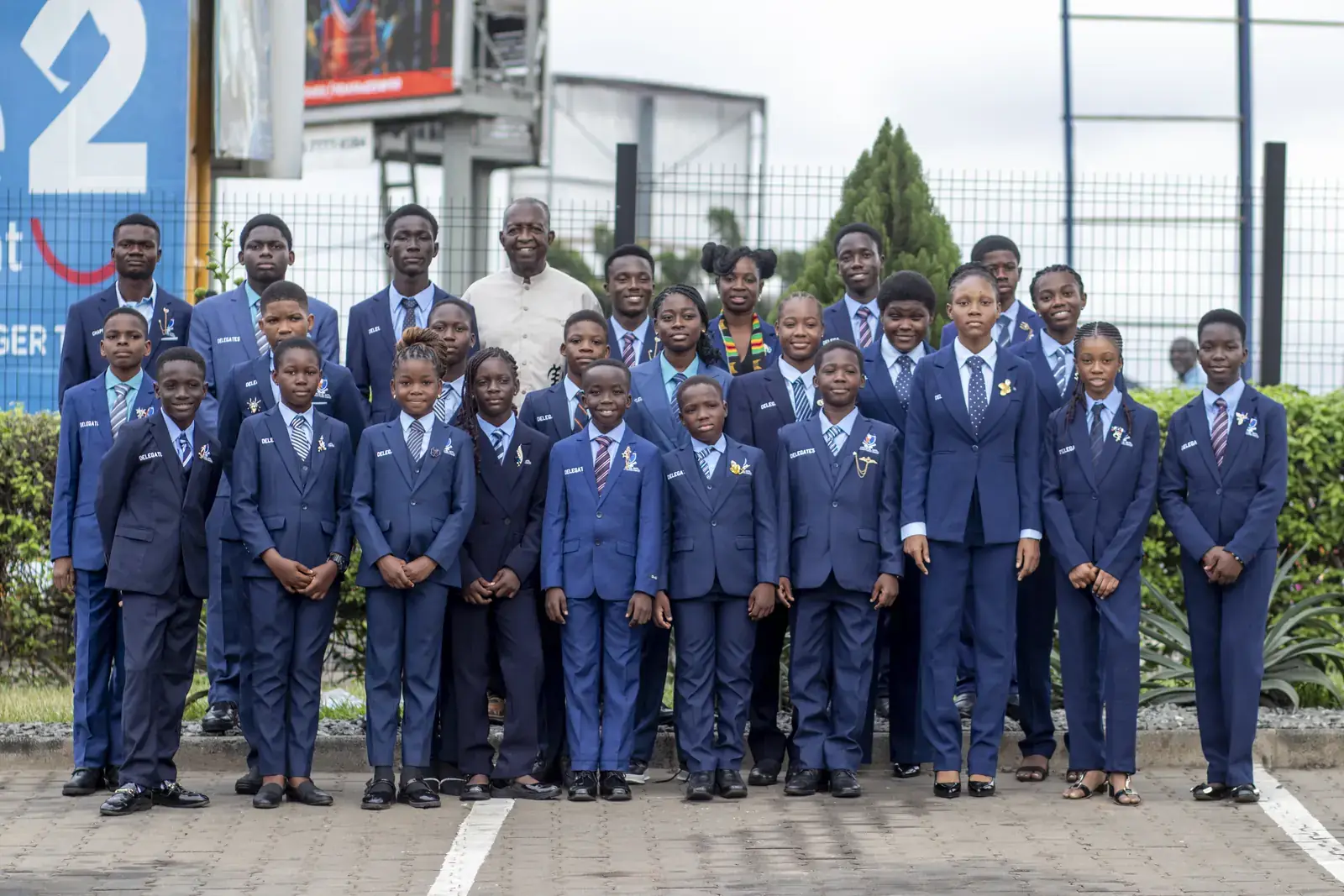 The group photographed together with the adults accompanying them on the field trip.