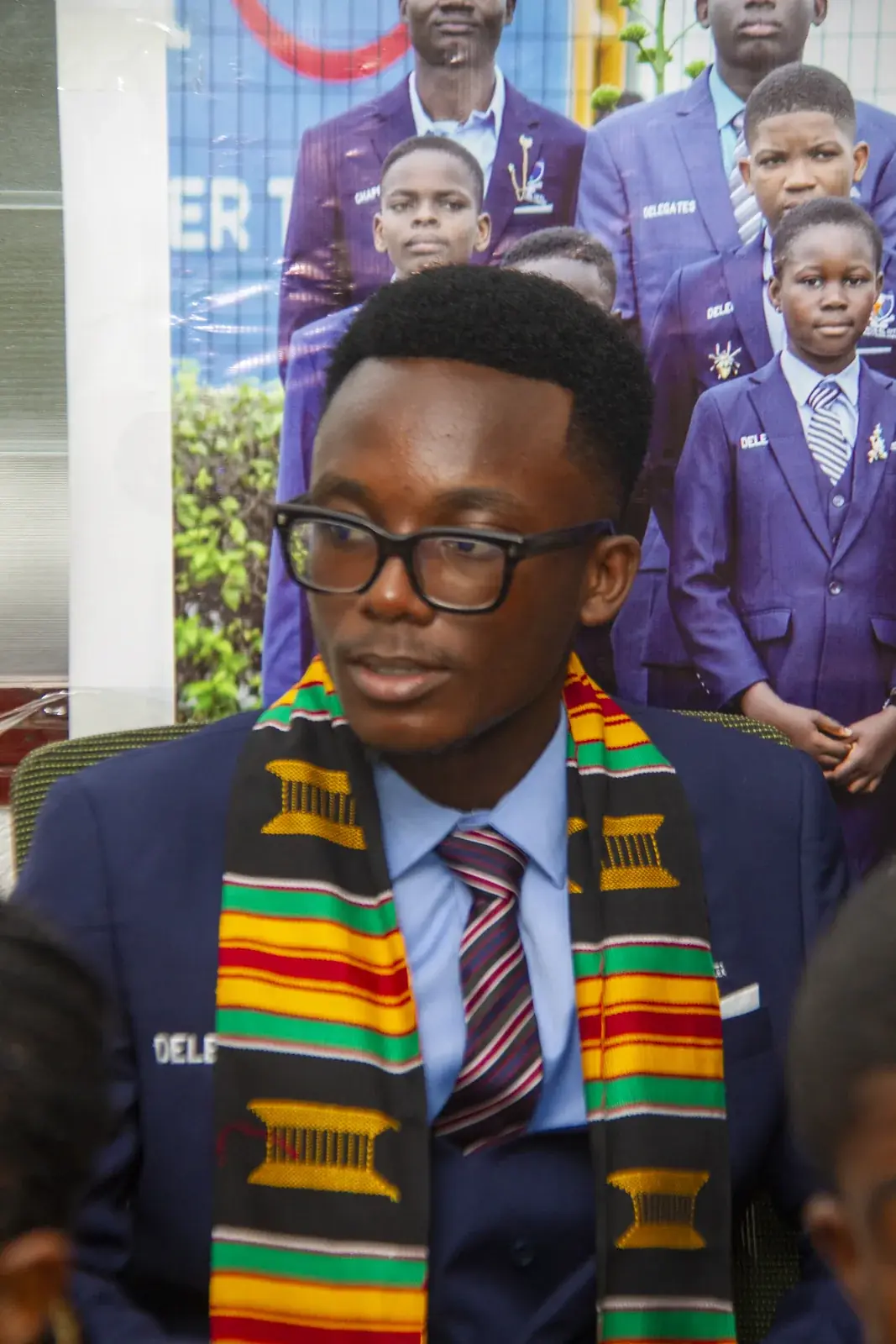 A member presenting to the group in front of the AVATI banner.