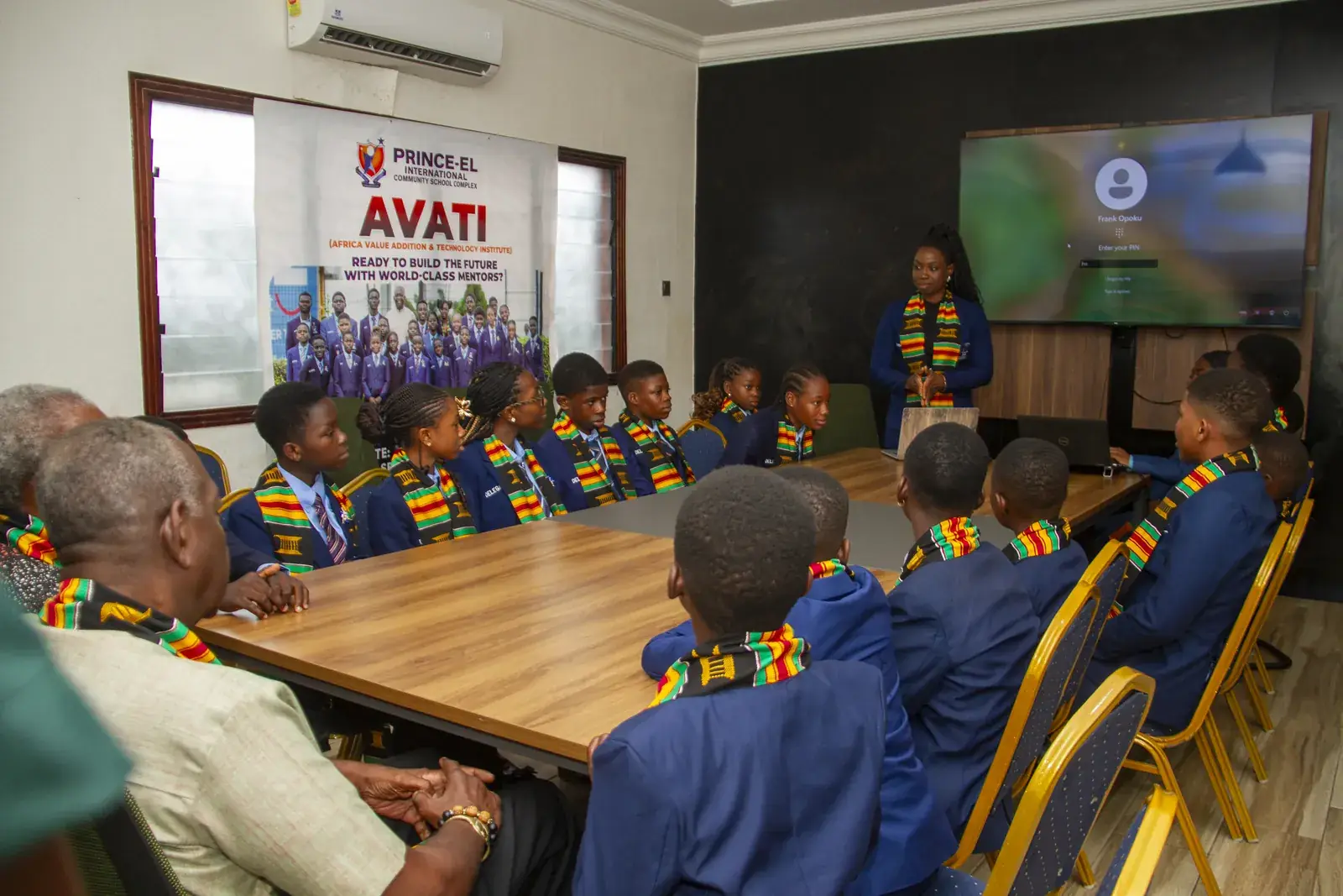 Members seated around the table at the East Legon venue as one of them presents to the group.