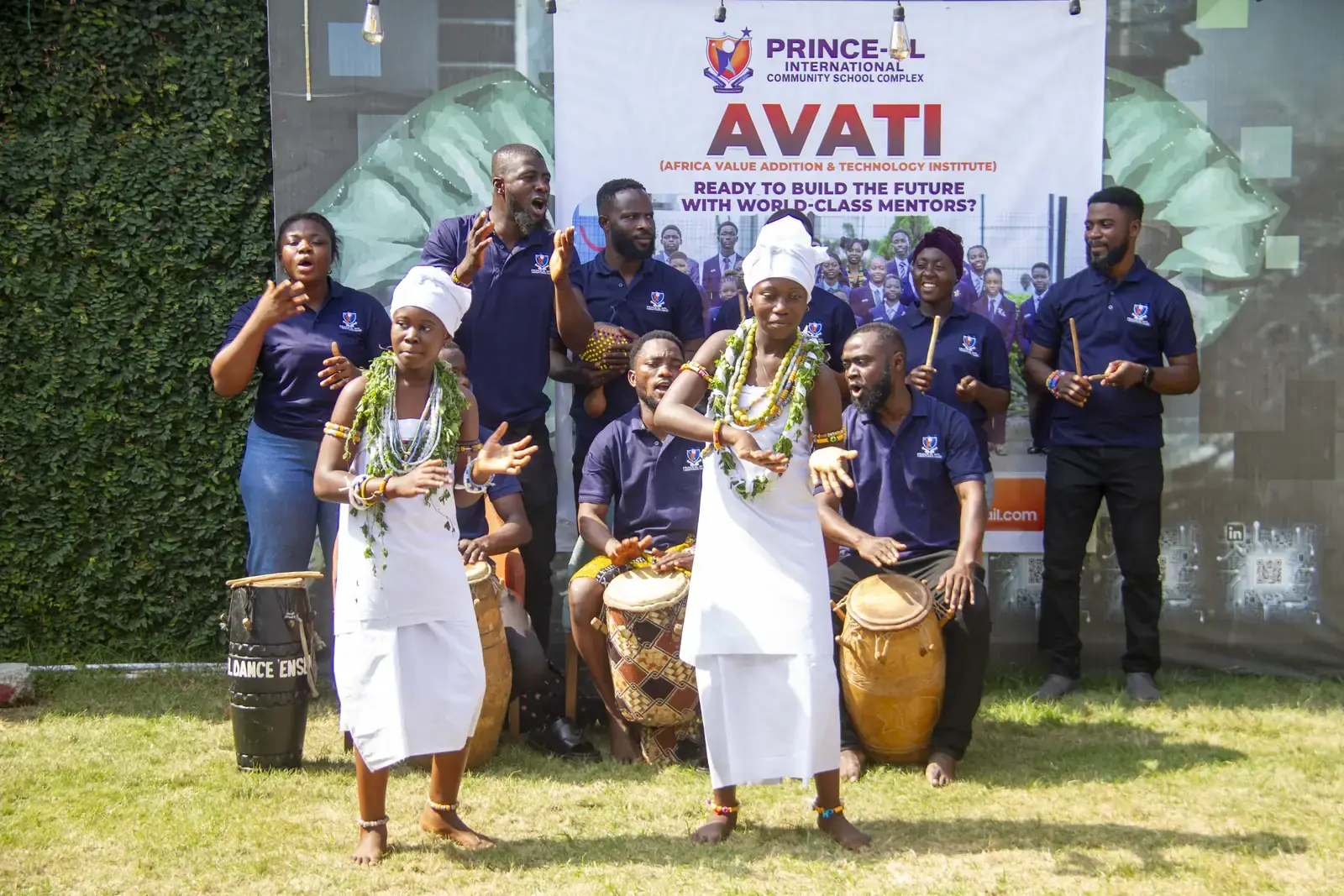 Members dancing together while the drummers accompany them.
