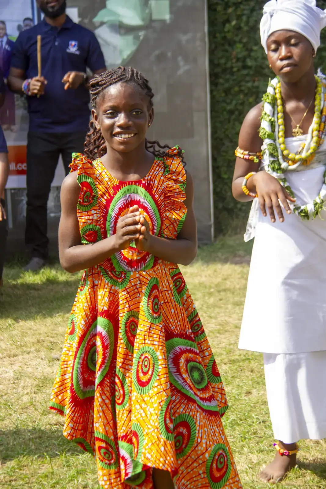A member in traditional dress during the cultural display.